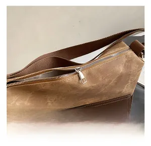 Close-up of smooth silver metal zipper and durable brown canvas texture on tote bag