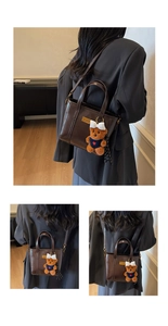 Detail of dark brown vintage cross-body bag with cute plush bear charm and glossy finish
