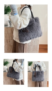 Macro shot of fluffy grey faux fur tote with a thick black chain strap and metal charm