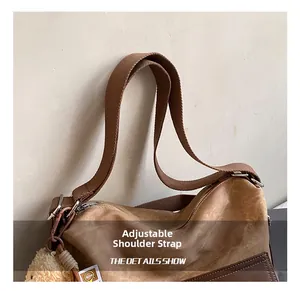 Detail showing adjustable shoulder strap with silver metal buckles on a brown tote bag
