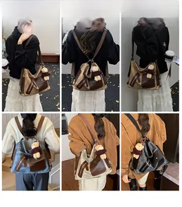 Detail view of canvas backpack with leather patchwork and multiple zipper pockets