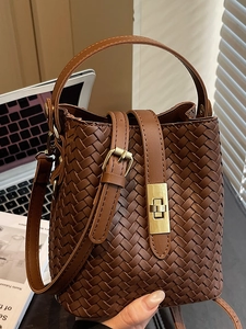 Deep brown woven bucket bag with golden twist lock and versatile crossbody strap