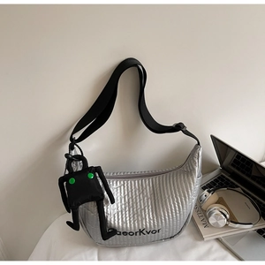 Detail of silver quilted dumpling bag with adjustable strap and robot charm