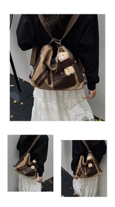 Detail of khaki canvas tote bag with brown leather trim and cute bear charm accessory