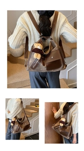 Detail of canvas leather tote showing zipper pockets and plush bear charm on the strap