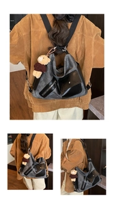 Detailed views of grey canvas tote bag with black pockets and a bear charm accessory