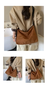 Detail view of large brown suede shoulder bag featuring a soft texture and black wide strap