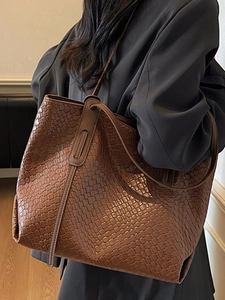 Chic brown woven leather tote bag with long shoulder straps for autumn 2025 fashion