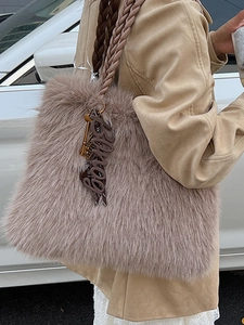 Chic lotus pink fluffy plush tote bag with woven handles and decorative charm detail