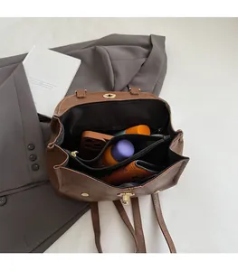 Detail view of the large capacity interior and multi-layer storage of this vintage brown backpack
