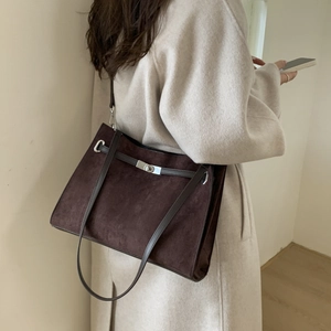 Deep brown matte suede tote bag showing its large capacity and silver twist-lock detail