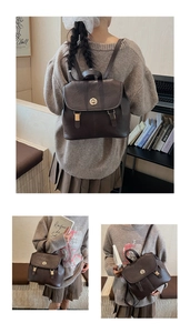 Detail view of a vintage dark brown leather backpack with gold clasp and buckle straps