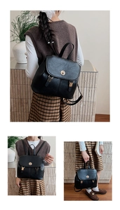 Detail view of black vintage textured backpack with golden metal twist lock and strap accents