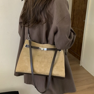 Model view showing the large vintage matte leather tote bag worn over the shoulder