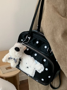 Polka dot black shoulder bag with cute plush puppy charms and glossy finish