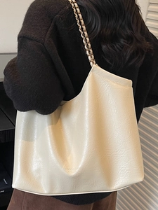 Minimalist cream tote bag with stylish chain straps and elegant wrinkled faux leather finish