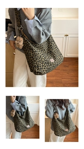 Detailed close-up of leopard print canvas tote bag with a plush bear charm accessory