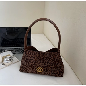 Close-up of leopard print shoulder bag with gold double-ring buckle and leather strap