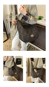 Close-up of leopard print hobo bag with teddy bear charm and wide shoulder strap