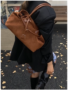 Caramel brown suede tote bag showing large capacity and leather texture on a model