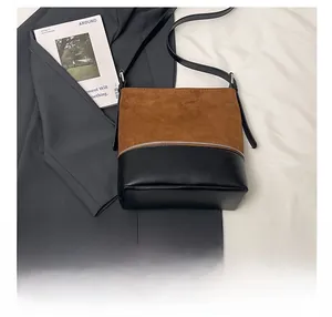 Detail of two-tone tote bag with brown suede and black leather including size comparison