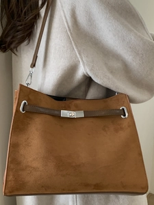 Brown vintage suede tote bag with silver twist lock shown on a model for autumn style