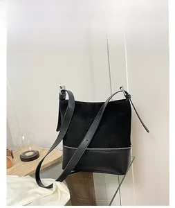 Detailed macro view of black tote bag showing mixed matte and smooth leather textures