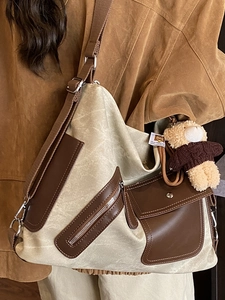 Retro canvas tote bag with brown leather trim and cute teddy bear pendant for travel