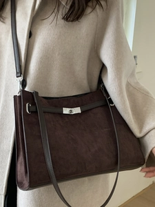 Vintage dark brown suede tote bag with silver twist lock shown on model shoulder