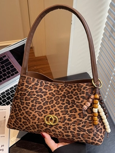 Chic leopard print underarm bag with gold metal hardware and stylish wooden bead detail