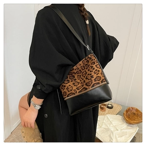 Close-up of leopard print patchwork shoulder bag with sleek metal zipper detail