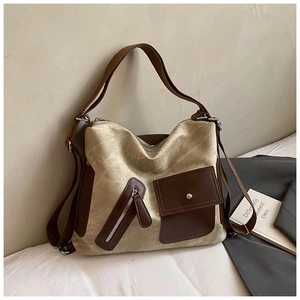 Borsa tote in tela beige con tasche in pelle marrone e tracolle regolabili alla moda