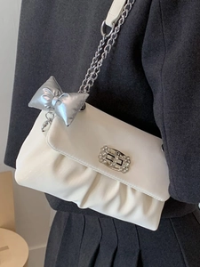 Chic white pleated crossbody bag with silver chain strap and bow charm detail