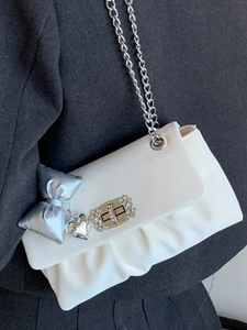 White pleated square crossbody bag with silver chain strap and rhinestone turn-lock