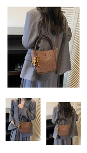Detailed view of leopard print faux suede bucket bag with colorful wooden beaded charm