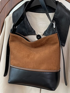 Brown suede and black leather patchwork tote bag with stylish metal zipper details