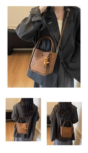 Detail view of large brown leopard print bucket bag with suede texture and wooden beads