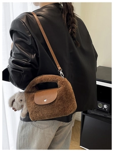 Detail of caramel faux fur bag with leather flap and cute plush bunny charm