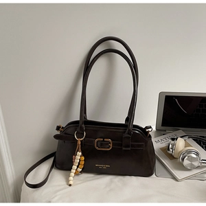 Detail view of dark brown retro leather tote bag with wooden beads and golden buckle