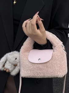 Pink plush handbag with leather flap and cute rabbit pendant for stylish crossbody wear