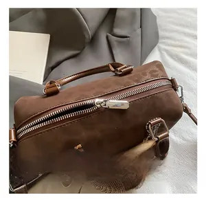 Detail of silver zipper and smooth brown leather texture on a Boston style handbag
