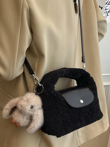 Chic black fleece crossbody bag with plush bunny pendant and silver buckle detail
