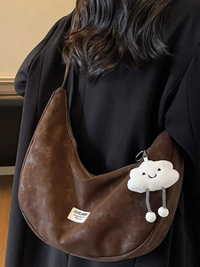 Brown oversized hobo bag in suede texture with a cute white cloud pendant accessory
