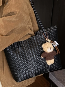 Large vintage woven leather tote bag in black with contrast stitching and bear charm