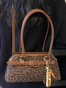 Retro leopard print underarm bag with brown leather straps and beaded charm detail