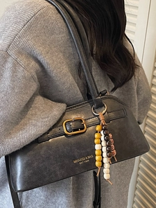 Vintage black faux leather underarm bag with gold buckle and beaded charm accessory