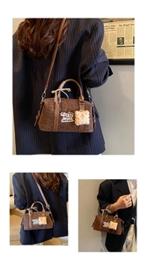 Detail of vintage leopard print Boston bag with plush cookie pendant and ribbon handle