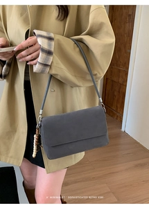 Minimalist dark gray crossbody bag with retro multi-color wooden bead charm detail