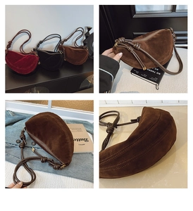 Close-up of minimalist suede crescent hobo bags with unique knotted shoulder straps