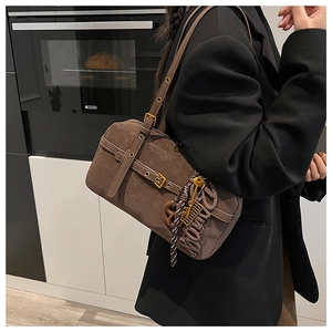 Side view of brown retro shoulder bag featuring large BONNY letter charm and buckle details